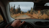 a person driving a car down a dirt road